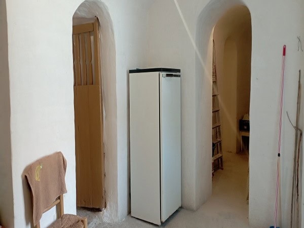 Cozy interior of a village property in Villanueva de las To, Granada, featuring a small refrigerator.