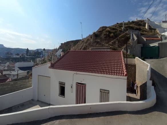 Charming village house with red-tiled roof in Villanueva de las To, Granada, offering scenic views a.