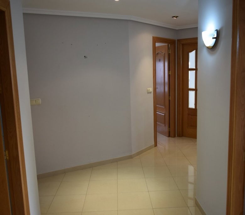 Apartment in Baza, Granada with wooden doors and bright interior.