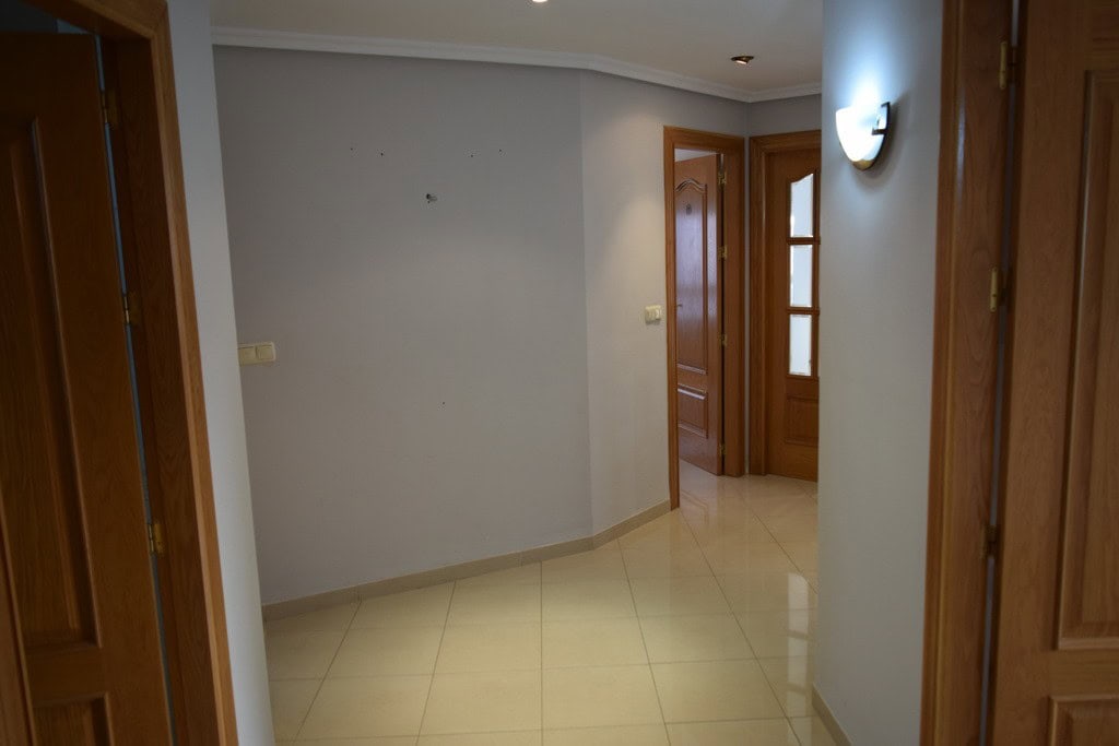 Apartment in Baza, Granada with wooden doors and bright interior.