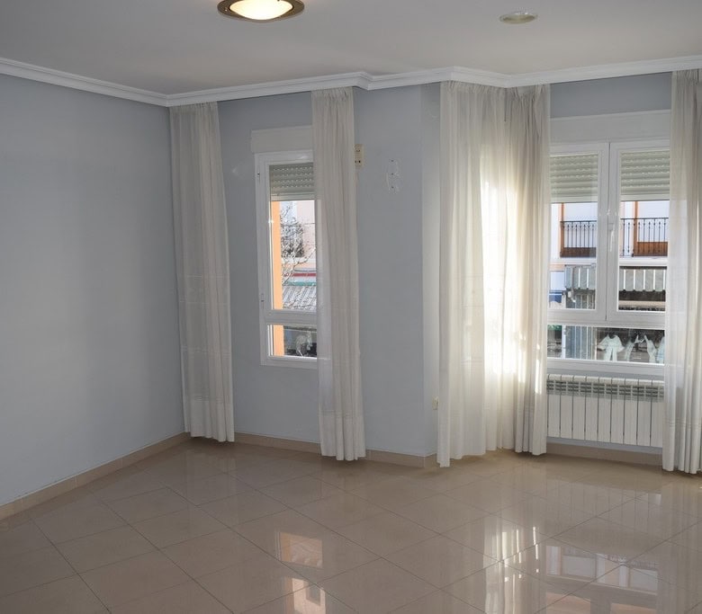 Bright living room with large windows in Baza, Granada.