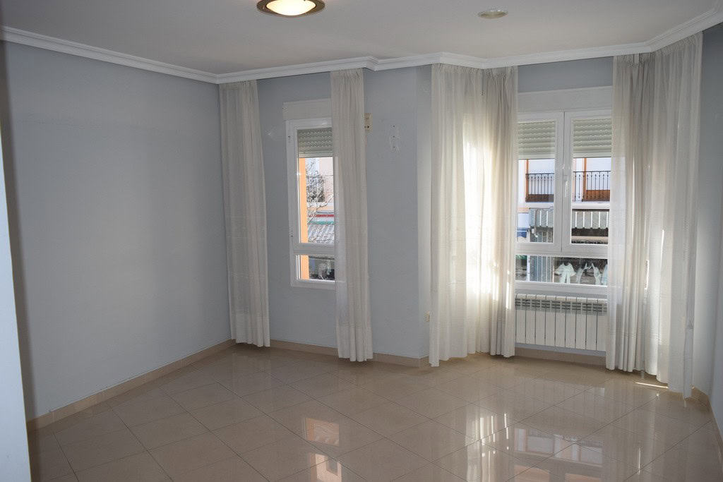 Bright living room with large windows in Baza, Granada.