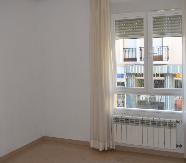 Bright apartment window with curtains in Baza, Granada.