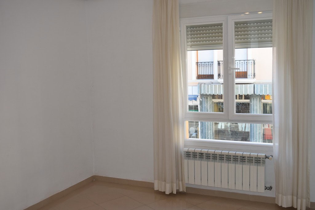 Bright apartment window with curtains in Baza, Granada.