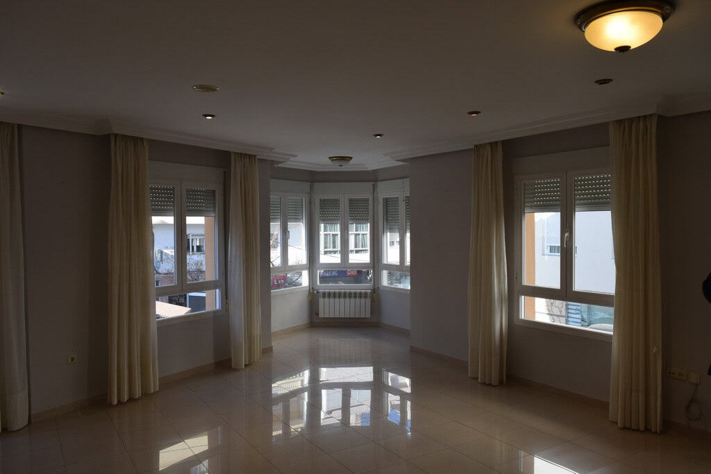 Bright living room with large windows in Baza, Granada.