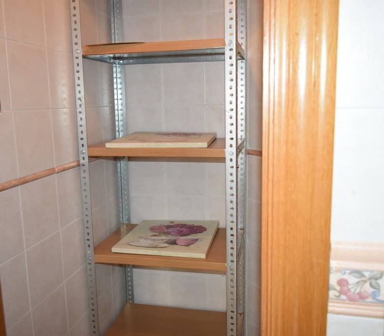 Storage shelf in apartment in Baza, Granada for organized living.