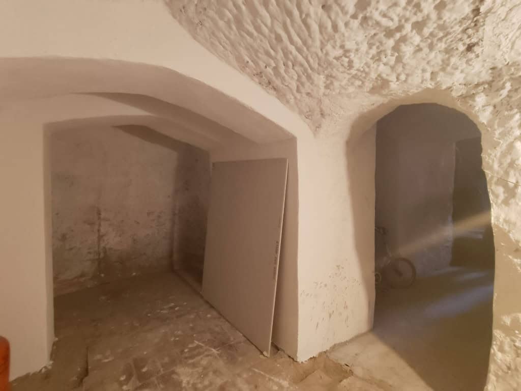Cave house interior in Guadix, Granada, showcasing traditional underground living spaces.