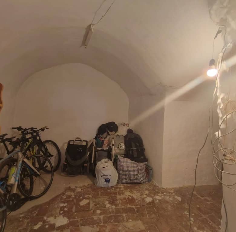 Cave house interior with bicycles and luggage in Guadix, Granada. Unique underground living space wi.