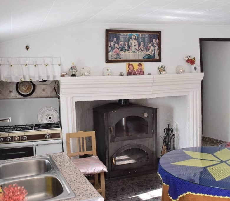 Charming rural property in Castril, Granada featuring a traditional fireplace and rustic interior. P.