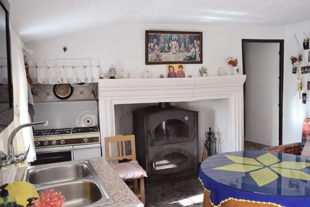Charming rural property in Castril, Granada featuring a traditional fireplace and rustic interior. P.