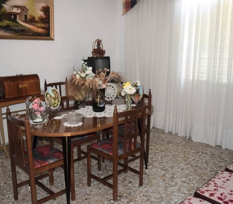 Charming rural property in Castril, Granada, featuring a cozy dining area with vintage furniture and.
