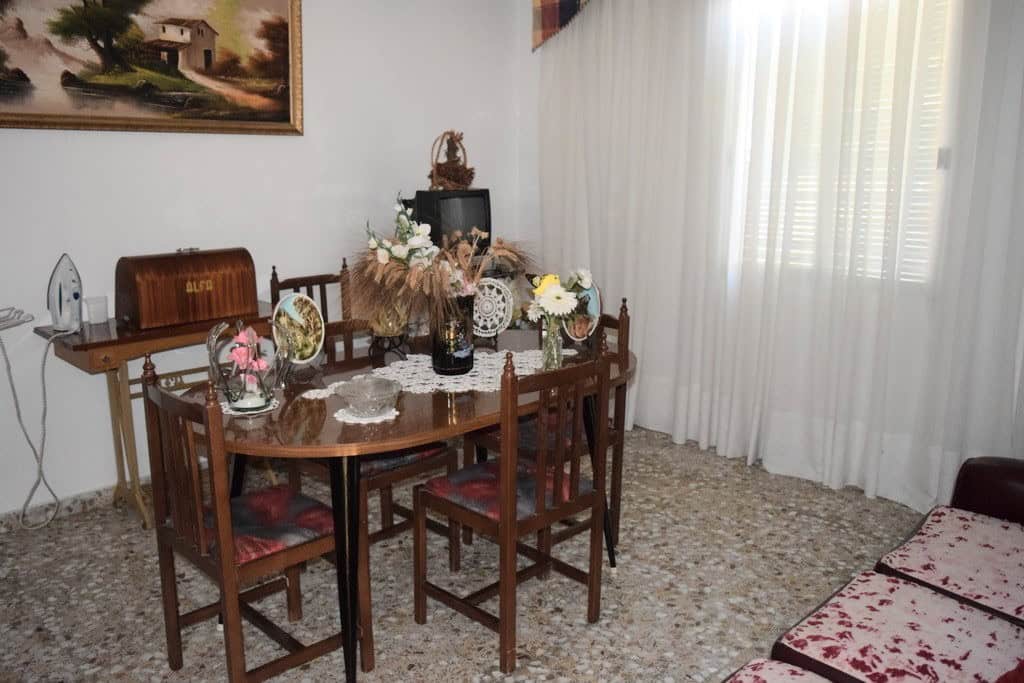 Charming rural property in Castril, Granada, featuring a cozy dining area with vintage furniture and.
