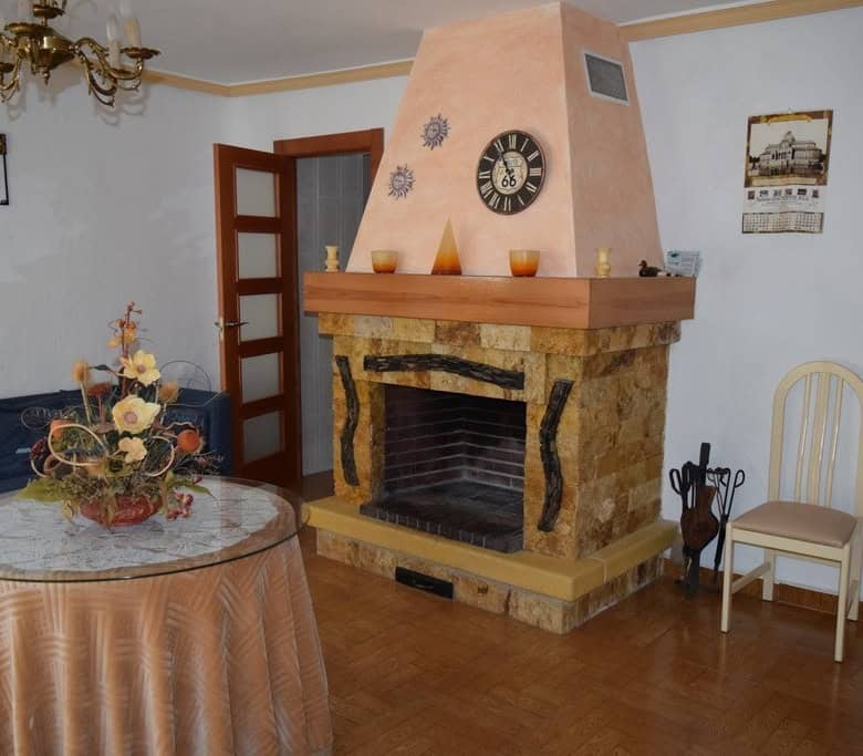 Charming living room with fireplace in rural property in Pozo Alcon, Jaen. Cozy interior with tradit.