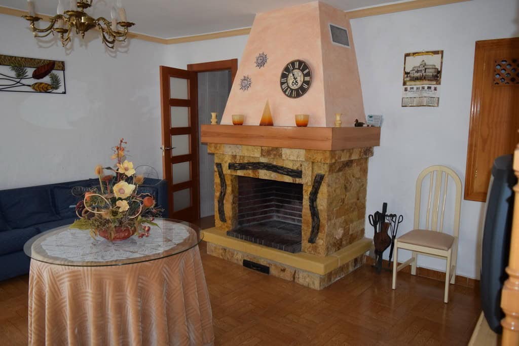 Charming living room with fireplace in rural property in Pozo Alcon, Jaen. Cozy interior with tradit.