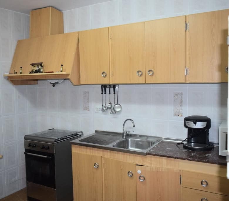 Cozy kitchen in a rural property located in Pozo Alcon, Jaen, featuring wooden cabinets, a stove, an.