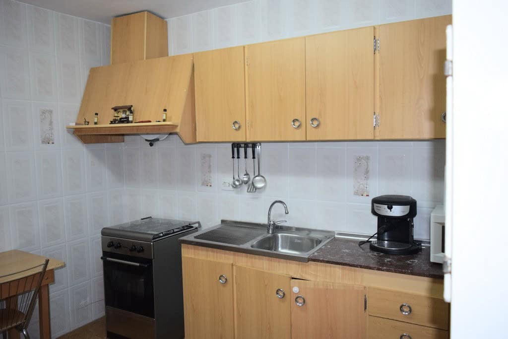 Cozy kitchen in a rural property located in Pozo Alcon, Jaen, featuring wooden cabinets, a stove, an.