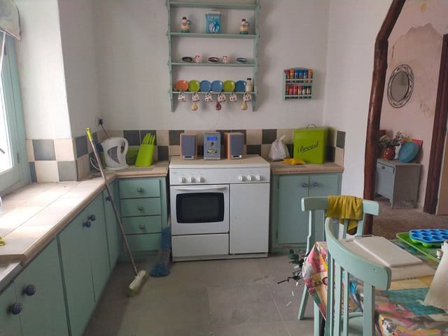 Cozy kitchen in Los Olivos, Granada with colorful dishes and rustic decor. Perfect for a peaceful vi.