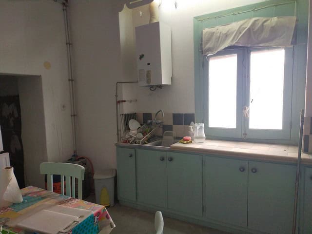 Charming village property in Los Olivos, Granada, featuring a cozy kitchen with a window and traditi.