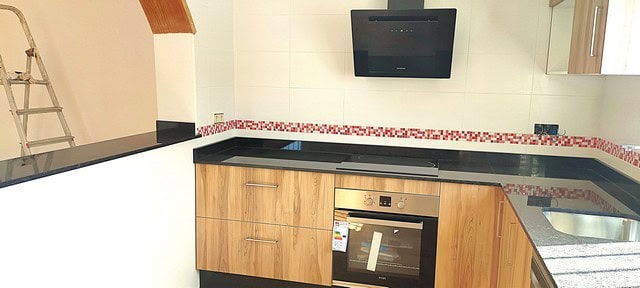 Kitchen with wooden cabinets and modern appliances in Villa Cantoria, Almeria.