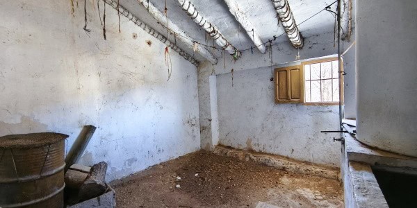 Interior view of a rustic village property in Fontanar, Jaen, showing unfinished walls and exposed c.