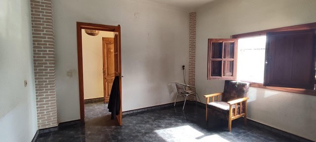 Spacious interior of a rural property in Seron, Almeria, featuring a bright room with wooden window.