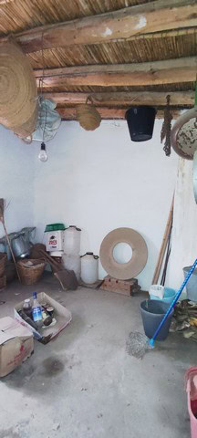 Traditional rural storage area in Seron, Almeria with wooden ceiling and basic household items.