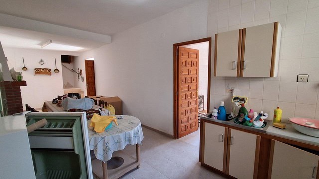 Charming rural home interior in Seron, Almeria, featuring a cozy kitchen and dining area with simple.