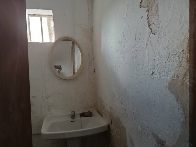 Rural property bathroom in Caniles, Granada with rustic charm and basic amenities. Ideal for renovat.
