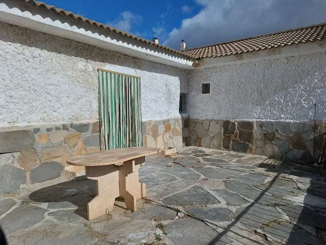 Charming rural property in Caniles, Granada featuring traditional stone walls and outdoor patio spac.
