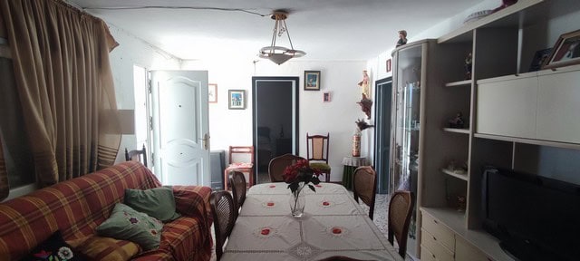 Charming rural home interior in Oria, Almeria, featuring a cozy living and dining area with traditio.