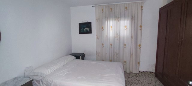 Charming bedroom in rural property in Oria, Almeria with simple decor and natural light.