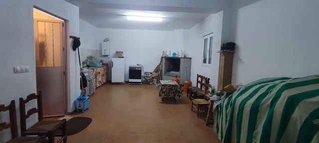 Spacious interior of a rural property in Oria, Almeria, featuring simple furnishings and a cozy atmo.