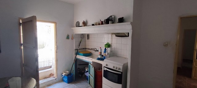 Cozy kitchen in a village property in Seron, Almeria, featuring basic appliances and simple decor.