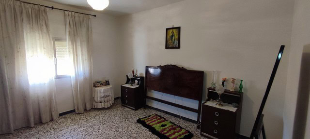Charming village home interior in Seron, Almeria, featuring a cozy bedroom with classic furnishings.