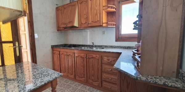 Charming kitchen in a village property located in Fontanar, Jaen, featuring wooden cabinets and gran.