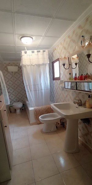 Bright bathroom with shower, toilet, and sink in a charming village property. Perfect for comfortabl.