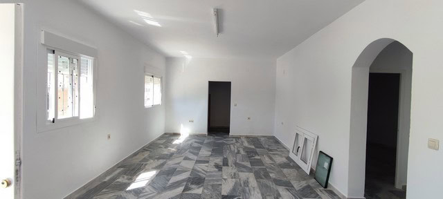 Interior view of a spacious, unfinished rural property in Macael, Almeria, with white walls and larg.