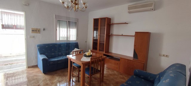 Bright living room with wooden furniture and sofas in Purchena, Almeria. Ideal for a peaceful villag.
