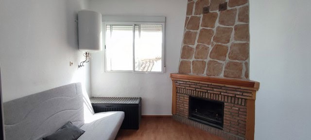 Cozy living room with fireplace and natural light in Purchena village, Almeria.
