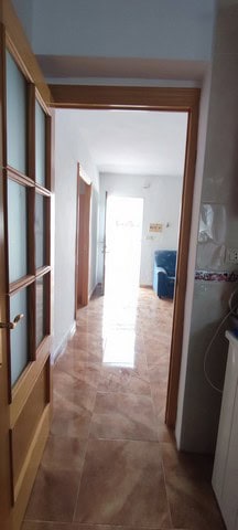 Charming village property interior with bright hallway and access to living spaces in Purchena, Alme.