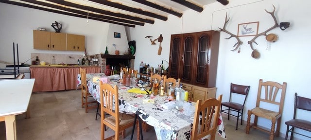 Rural property interior in Hijate, Almeria, featuring rustic decor, wooden beams, and traditional fu.