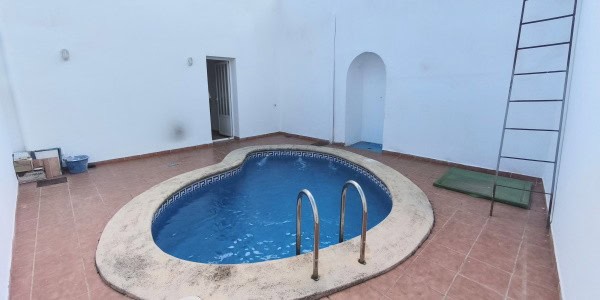 Village property in Fontanar, Jaen featuring a private swimming pool and outdoor patio area.
