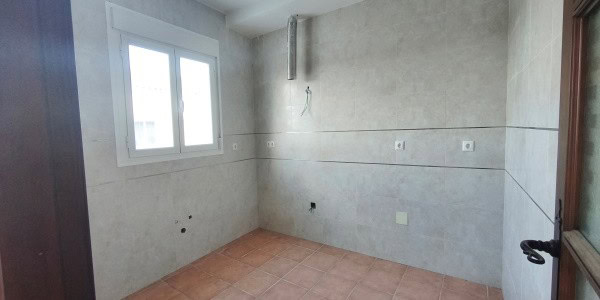 Bright interior of a village property in Fontanar, Jaen, with unfinished walls and a window providin.