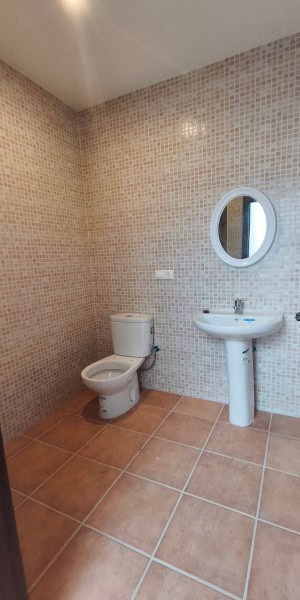 Bathroom with toilet and sink in a village property in Fontanar, Jaen.
