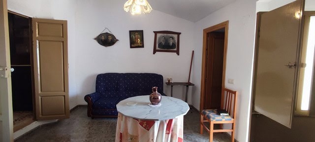 Interior view of a village property in Somontin, Almeria, with vintage furniture and simple decor.