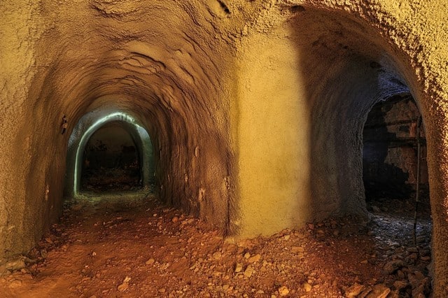 Cave house interior in Villanueva de las To, Granada, with tunnel-like rooms and rustic charm.