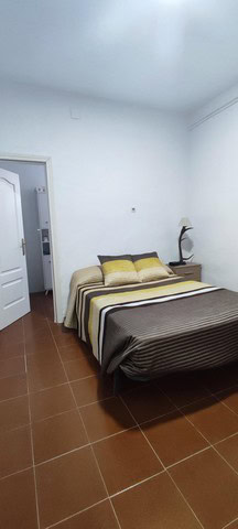 Charming bedroom in rural property located in Villanueva de las To, Granada, featuring simple decor.