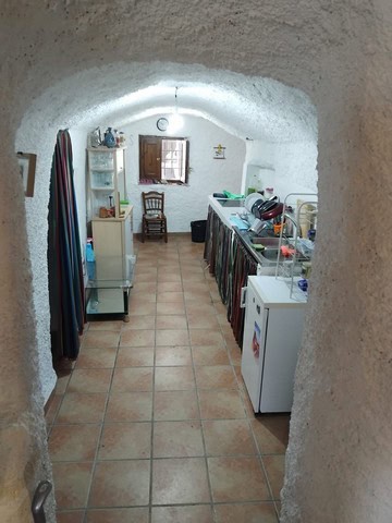 Cozy cave house interior with kitchen and rustic decor in Cantarranas, Granada. Unique underground l.