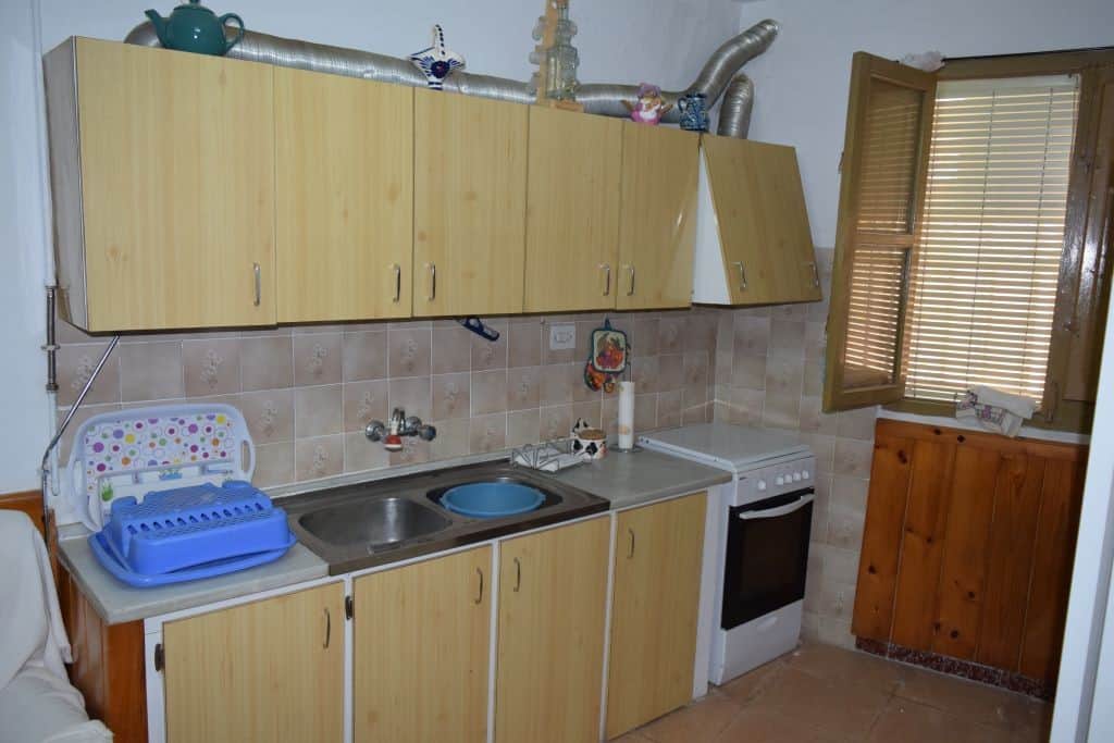 Charming cave house kitchen with basic appliances in Caniles, Granada, offering rustic living in a u.