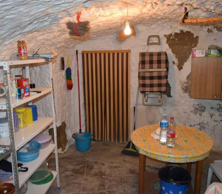 Unique cave house interior in Caniles, Granada, showcasing rustic charm and traditional living space.
